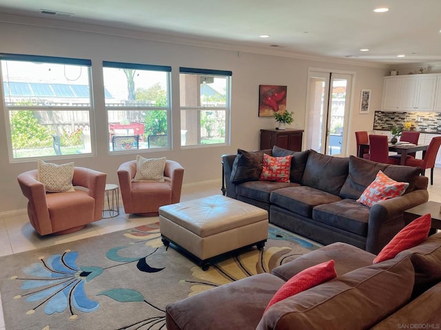 tiled living room with crown molding and a wealth of natural light