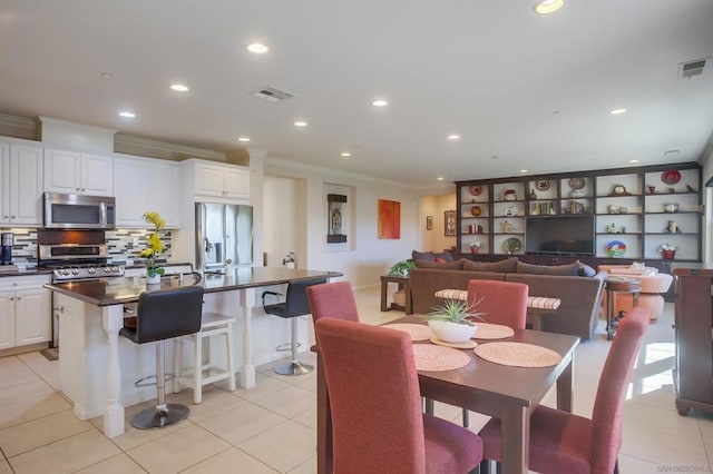 tiled dining space with ornamental molding