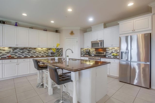 kitchen with white cabinetry, sink, a kitchen island with sink, and appliances with stainless steel finishes