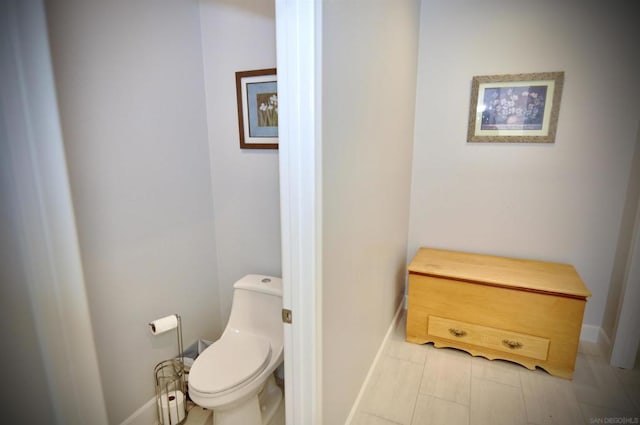 bathroom with tile patterned flooring and toilet