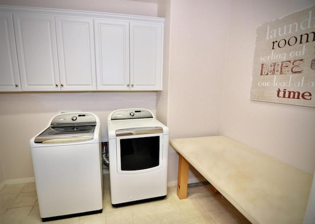 clothes washing area with cabinets, light tile patterned floors, and separate washer and dryer