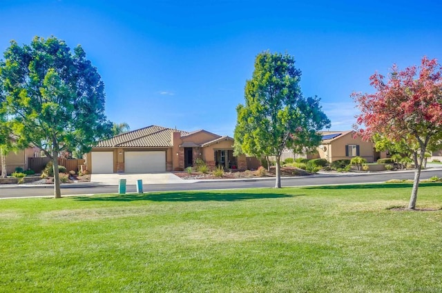 view of front of house featuring a garage and a front lawn