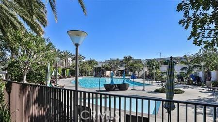 pool featuring fence and a patio