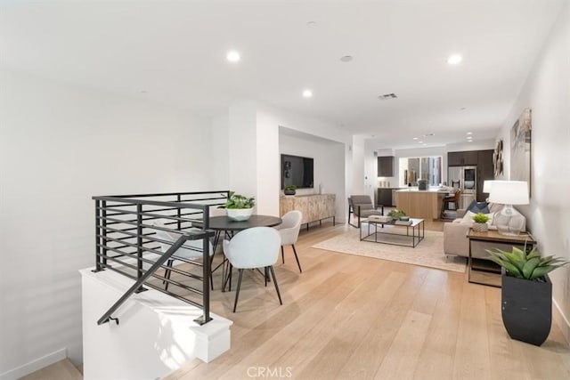 dining room featuring baseboards, recessed lighting, visible vents, and light wood-style floors