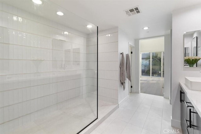 full bathroom with recessed lighting, visible vents, vanity, a walk in shower, and tile patterned floors