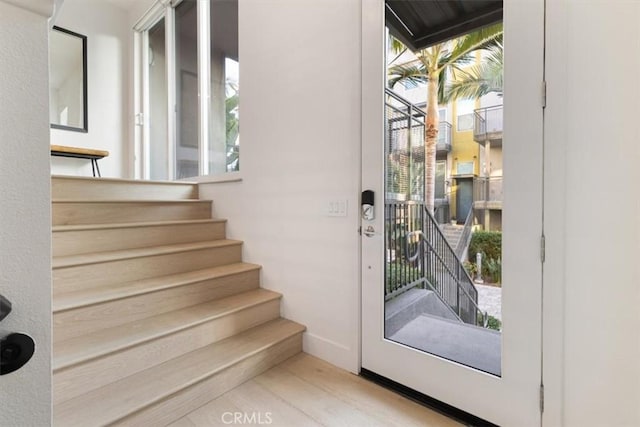 doorway with a healthy amount of sunlight and stairway