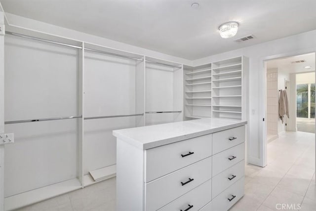 spacious closet featuring light tile patterned floors and visible vents