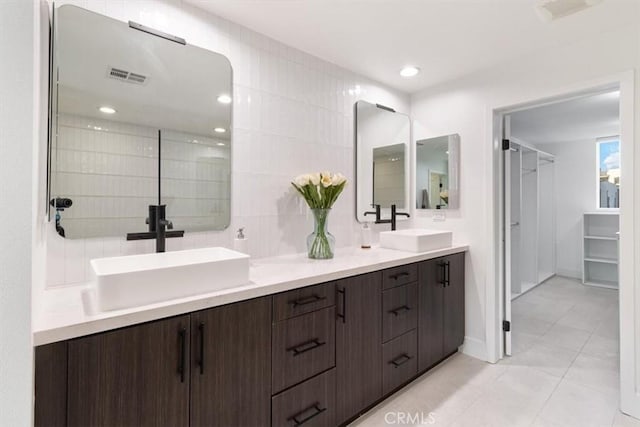 bathroom featuring double vanity, a sink, visible vents, and recessed lighting