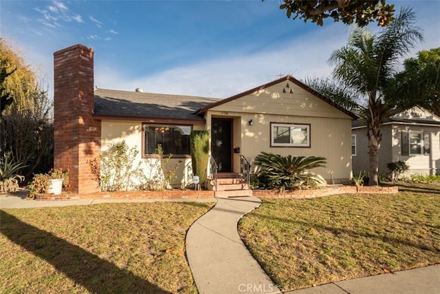 ranch-style home featuring a front yard