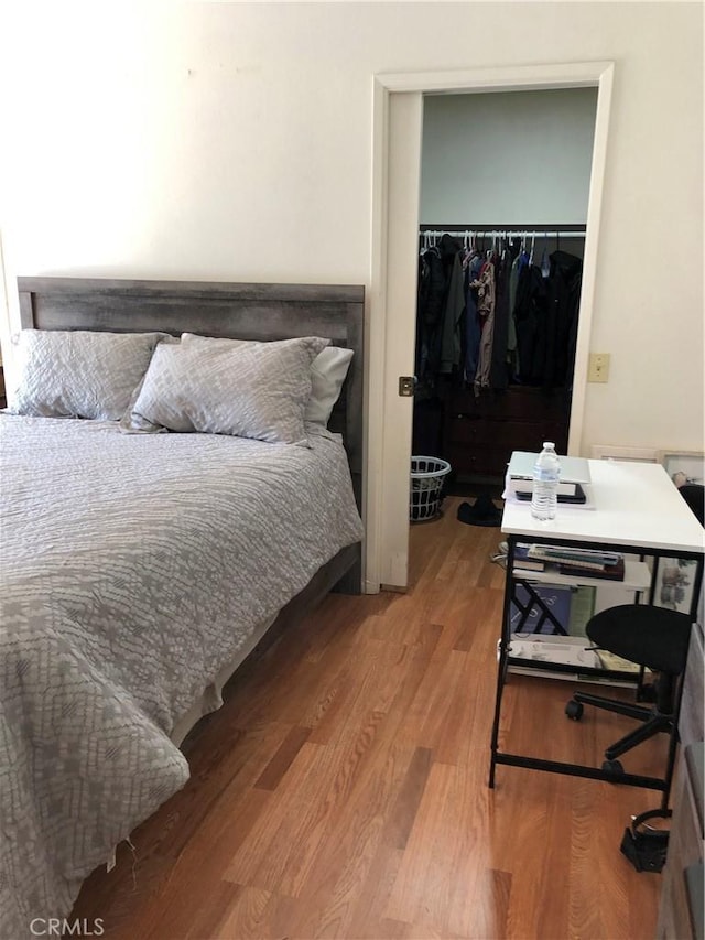 bedroom featuring hardwood / wood-style floors and a closet