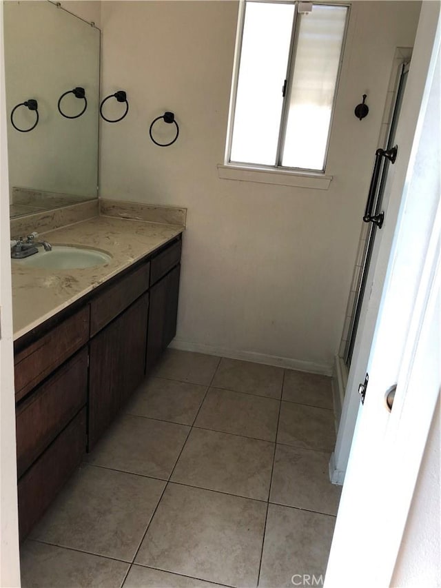 bathroom with tile patterned floors and vanity