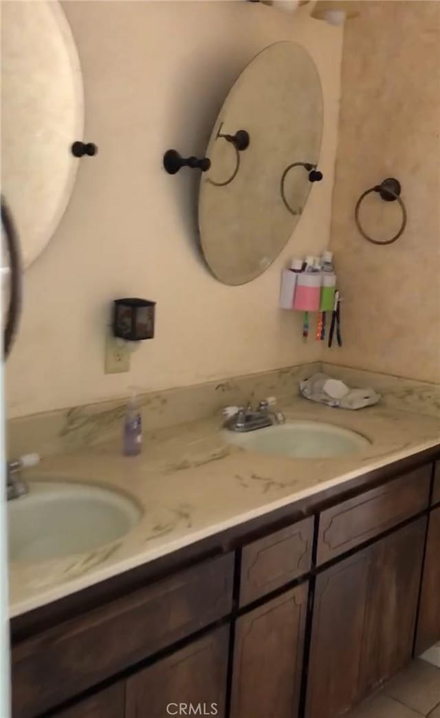 bathroom with tile patterned flooring and vanity