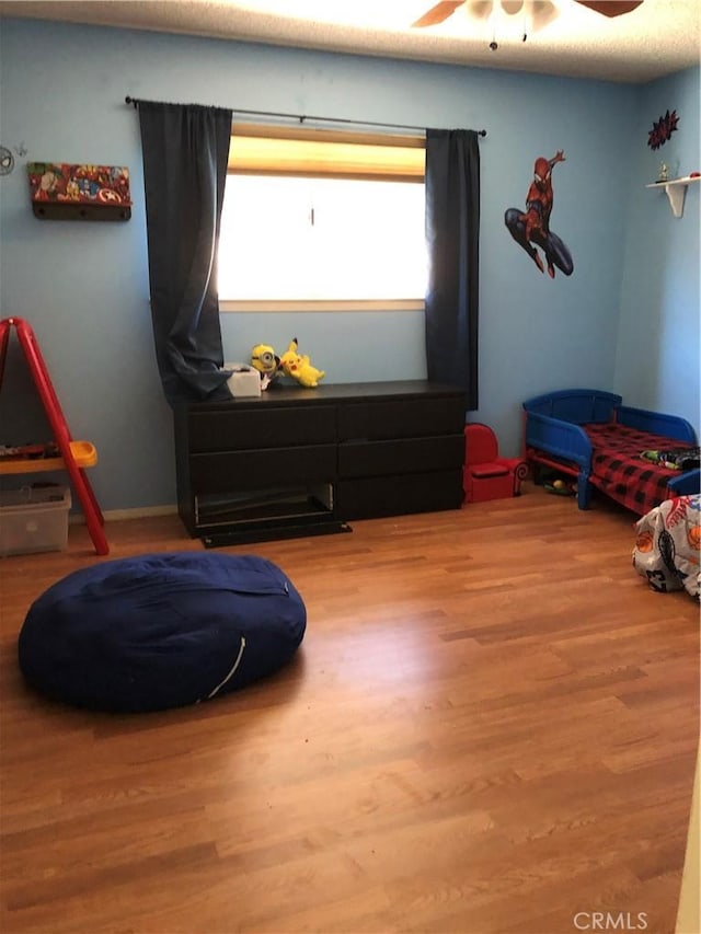 bedroom with hardwood / wood-style floors and ceiling fan