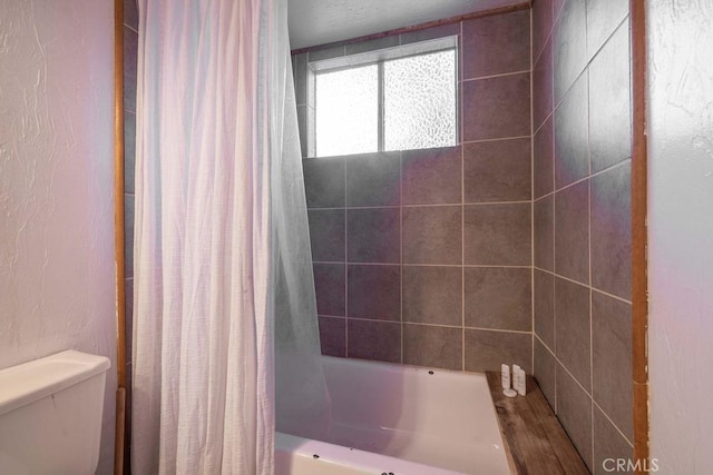 bathroom with shower / bath combo with shower curtain and toilet