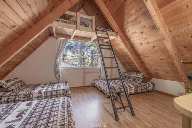 unfurnished bedroom featuring light wood-type flooring, lofted ceiling with beams, and wooden ceiling