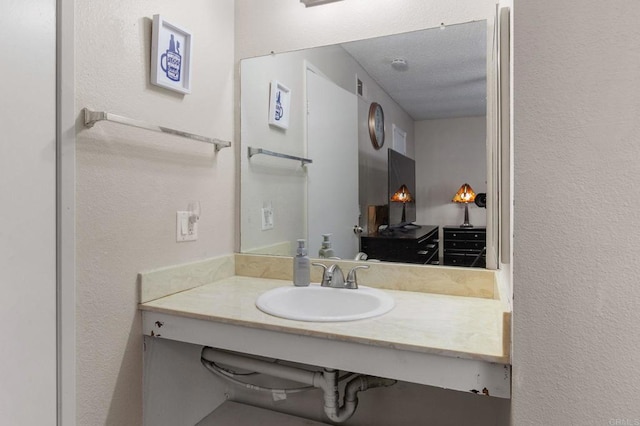 bathroom with vanity and a textured ceiling