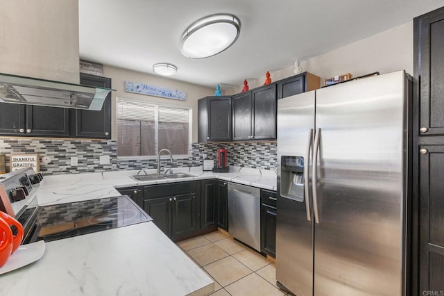 kitchen with sink, stainless steel appliances, tasteful backsplash, and light tile patterned flooring