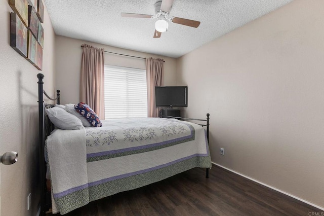 bedroom featuring ceiling fan, wood-type flooring, and a textured ceiling