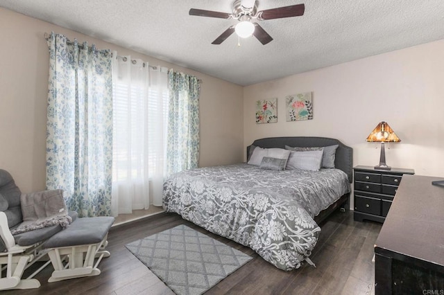 bedroom featuring ceiling fan, a textured ceiling, and dark hardwood / wood-style floors