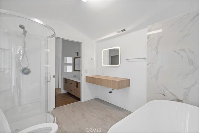 bathroom with hardwood / wood-style floors, vanity, walk in shower, and lofted ceiling