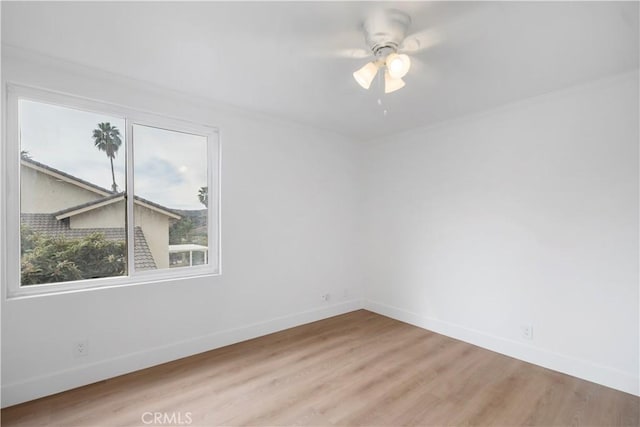 spare room featuring ceiling fan and light hardwood / wood-style floors