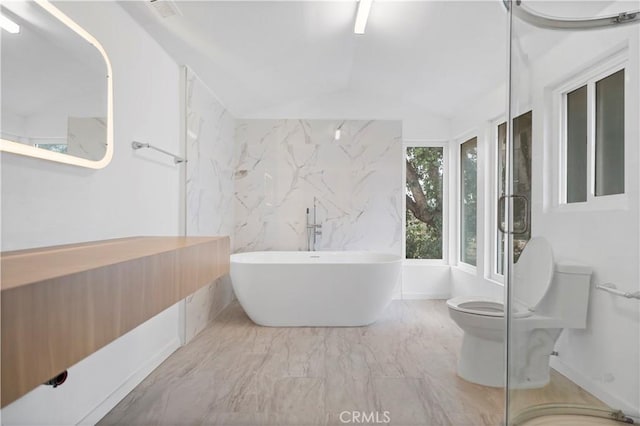 bathroom featuring a bathing tub and toilet