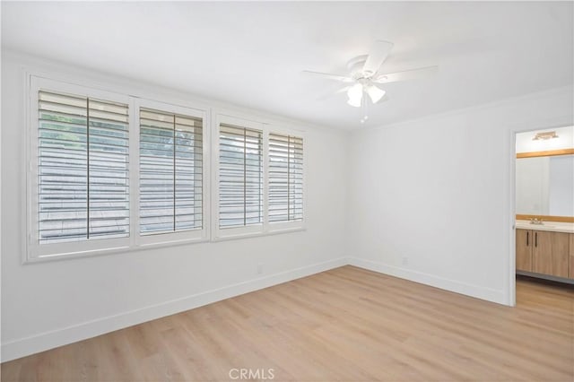 unfurnished room featuring crown molding, ceiling fan, sink, and light hardwood / wood-style floors