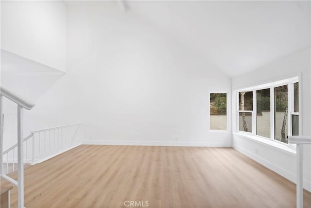 interior space featuring high vaulted ceiling and light hardwood / wood-style flooring