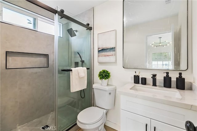 bathroom with vanity, an inviting chandelier, toilet, and walk in shower