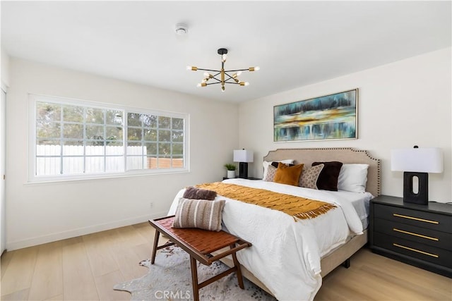 bedroom featuring a notable chandelier and light hardwood / wood-style flooring