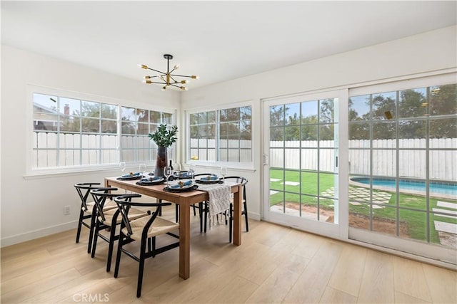 sunroom featuring a chandelier