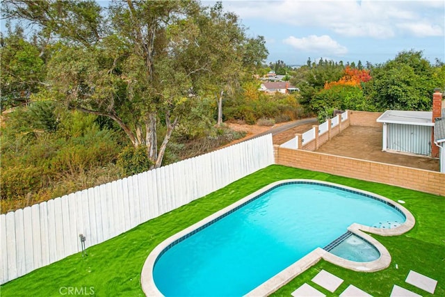 view of pool featuring a lawn