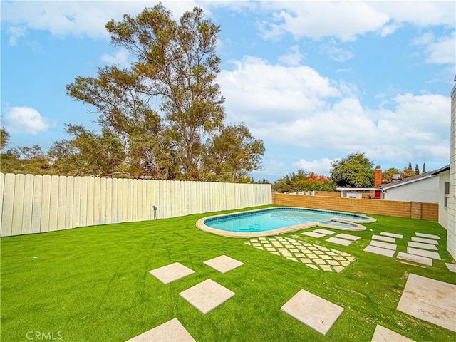 view of swimming pool featuring a yard and an outdoor hot tub