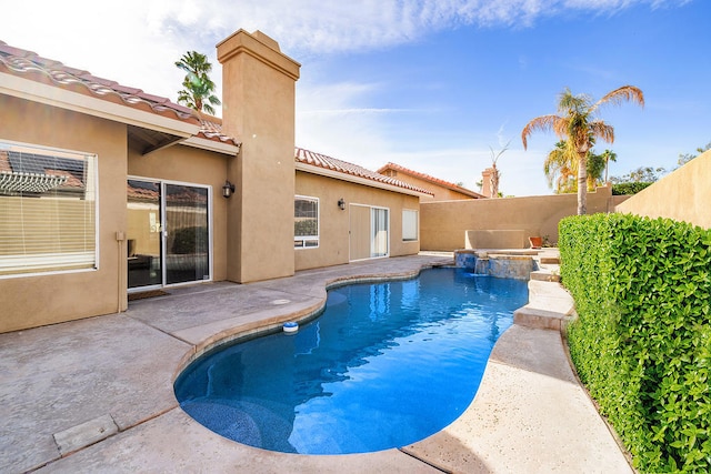 view of swimming pool featuring an in ground hot tub and a patio area