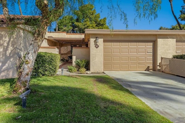 ranch-style home featuring a garage and a front lawn