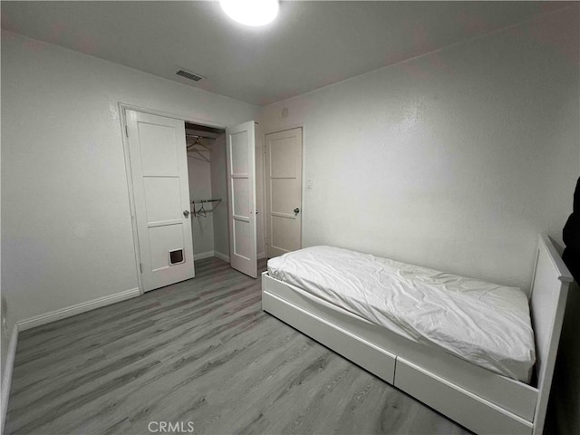 bedroom featuring light wood-type flooring and a closet