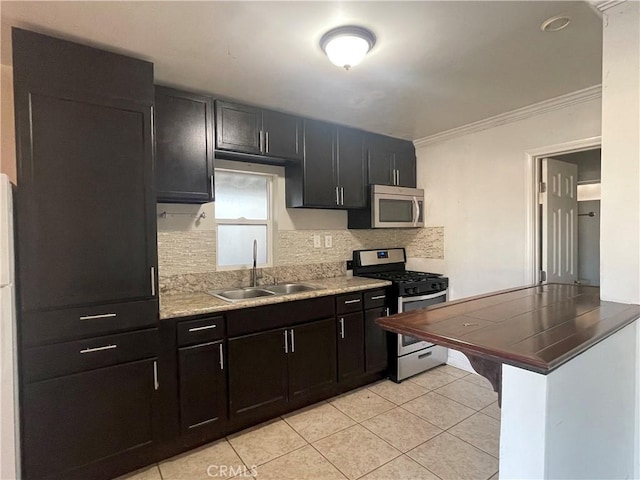 kitchen featuring backsplash, stainless steel appliances, crown molding, sink, and light tile patterned floors