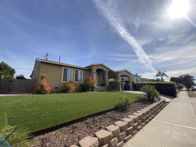 ranch-style home featuring a front yard