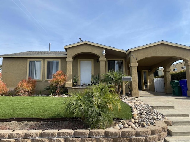 single story home featuring a front yard and a carport