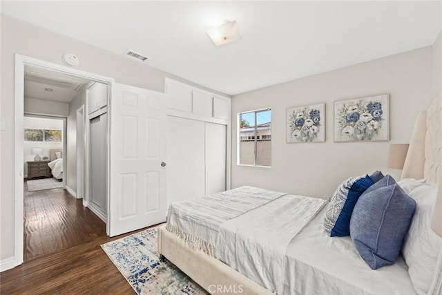 bedroom featuring a closet and dark hardwood / wood-style floors