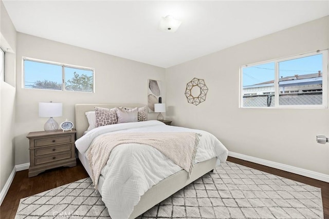 bedroom with hardwood / wood-style flooring and multiple windows