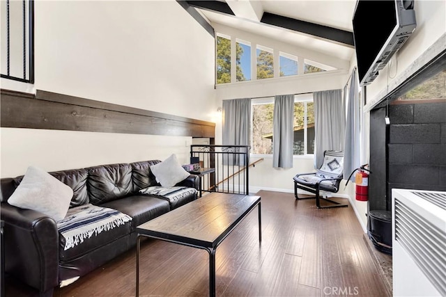 living room with beamed ceiling, dark hardwood / wood-style flooring, and high vaulted ceiling