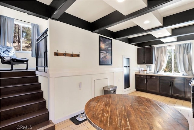 dining space with beam ceiling and plenty of natural light