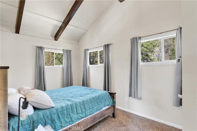 carpeted bedroom featuring lofted ceiling with beams