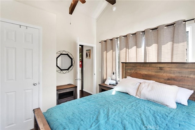 bedroom featuring beamed ceiling, high vaulted ceiling, and ceiling fan