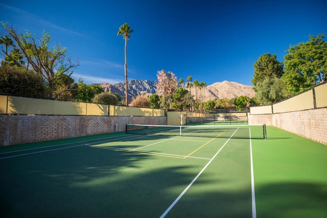 view of tennis court with a mountain view