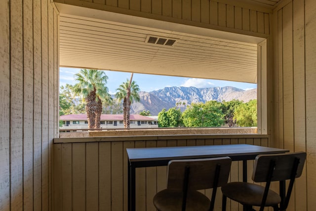 interior space with a mountain view and wood walls