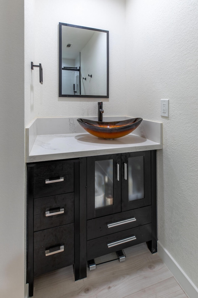 bathroom featuring hardwood / wood-style floors and vanity