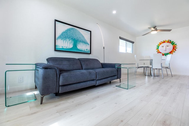 living room featuring ceiling fan and light hardwood / wood-style flooring