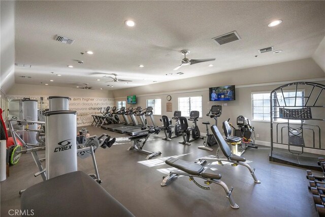 workout area featuring ceiling fan and a textured ceiling